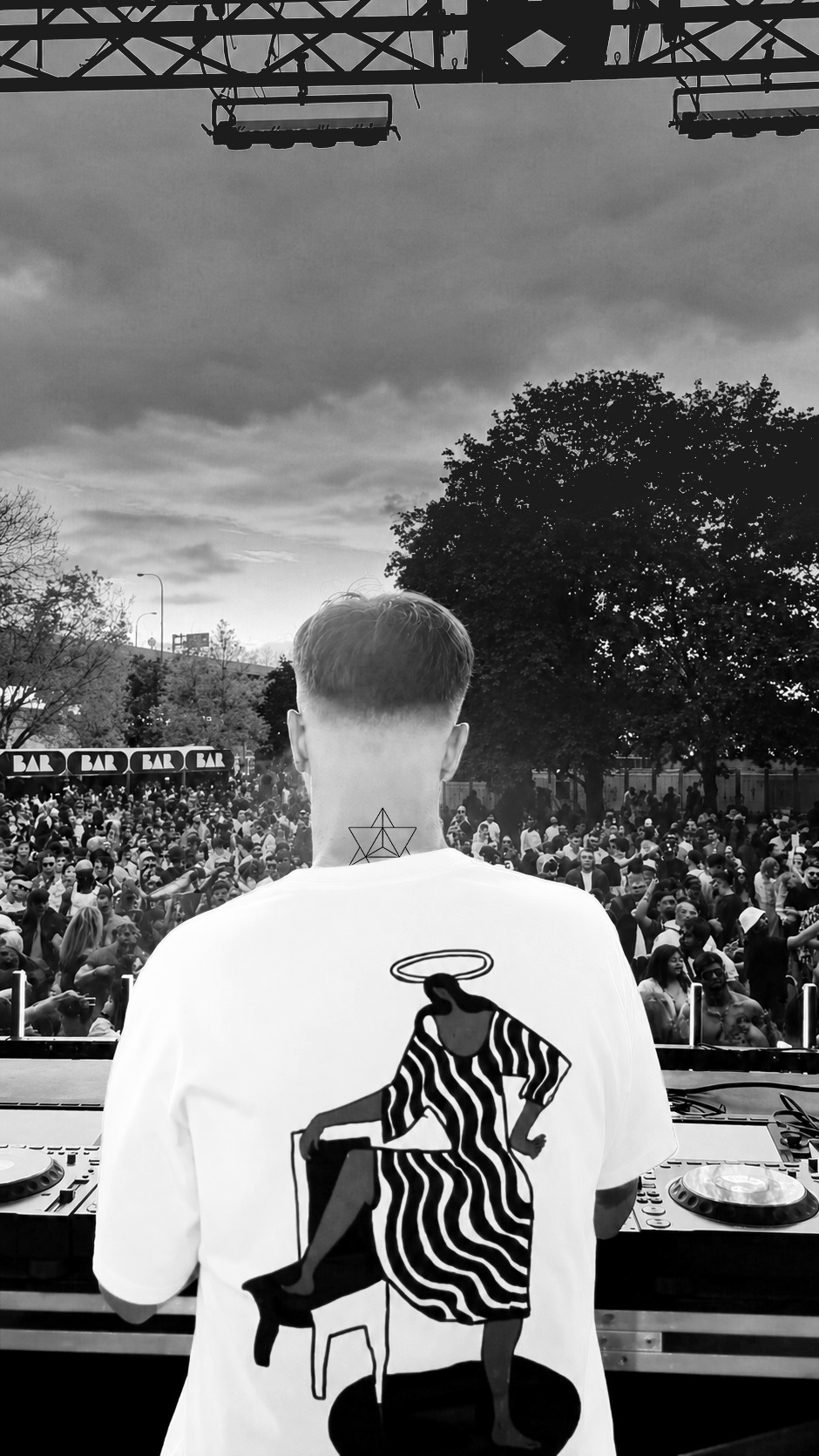 Jonathan Rosa at the decks, seen from behind, facing a big outdoor crowd